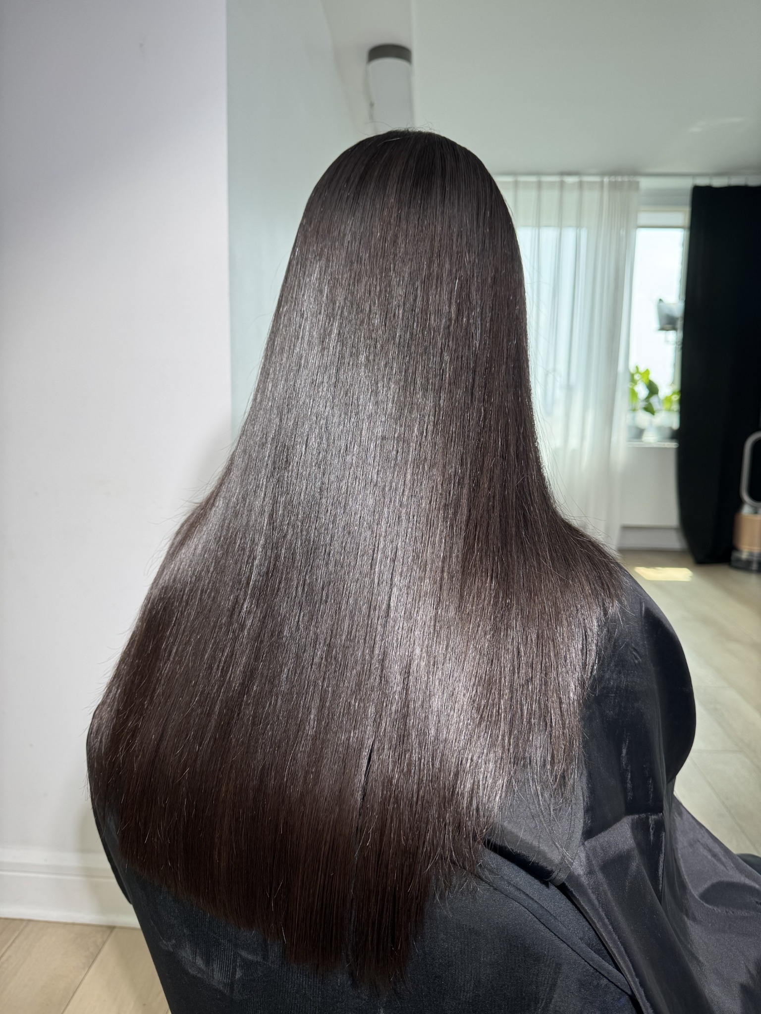 Long brunette hair showing smooth texture and shine after a hair service at A.Beauty.NYC