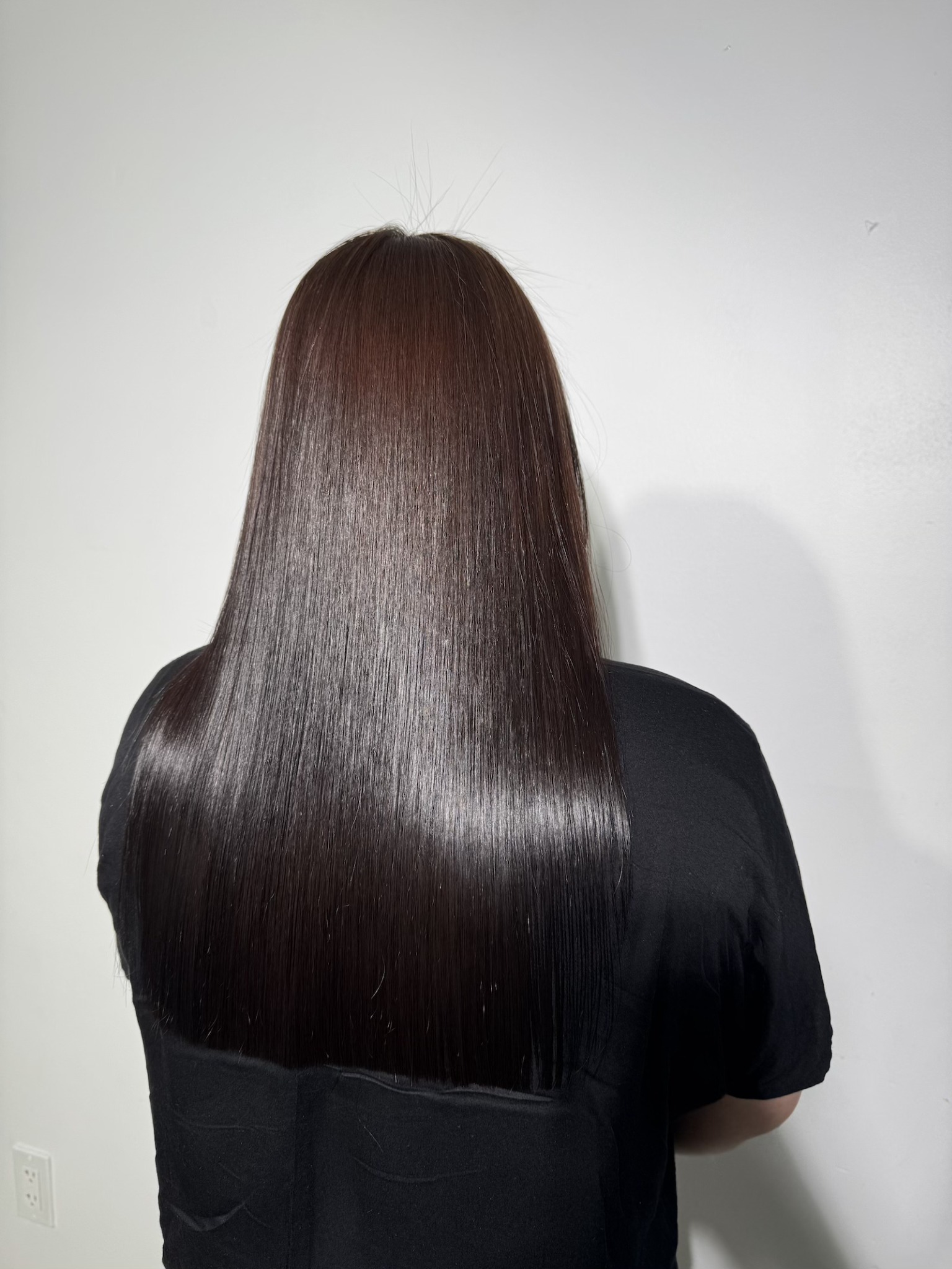 After: long dark hair with a smooth, straight finished appearance