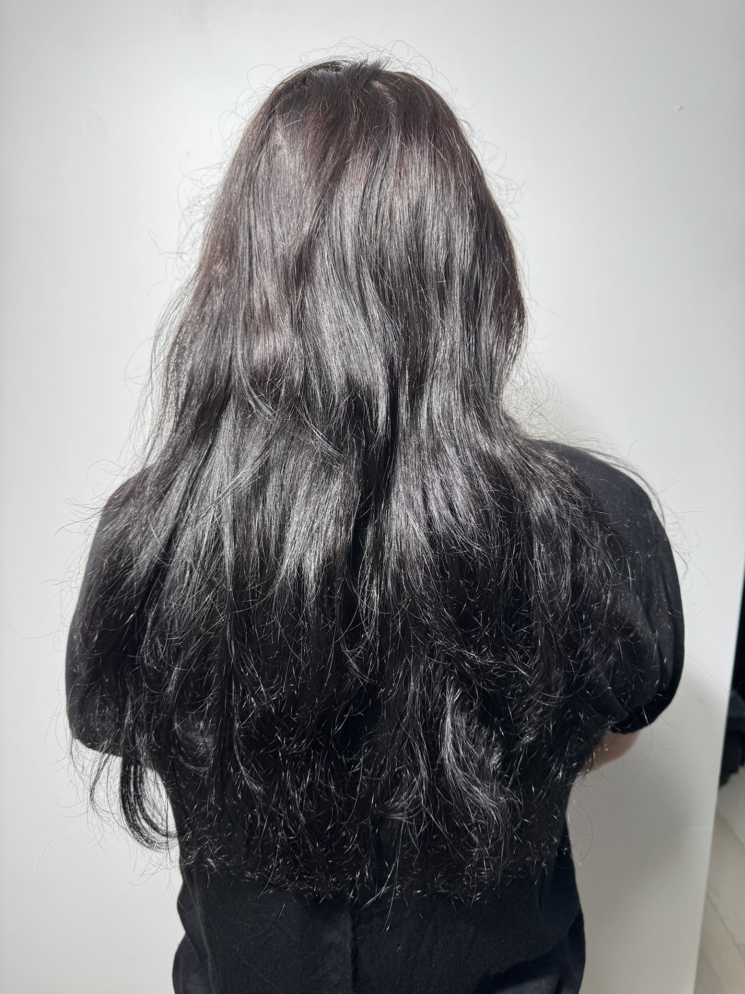 Before: long dark wavy hair prior to the service